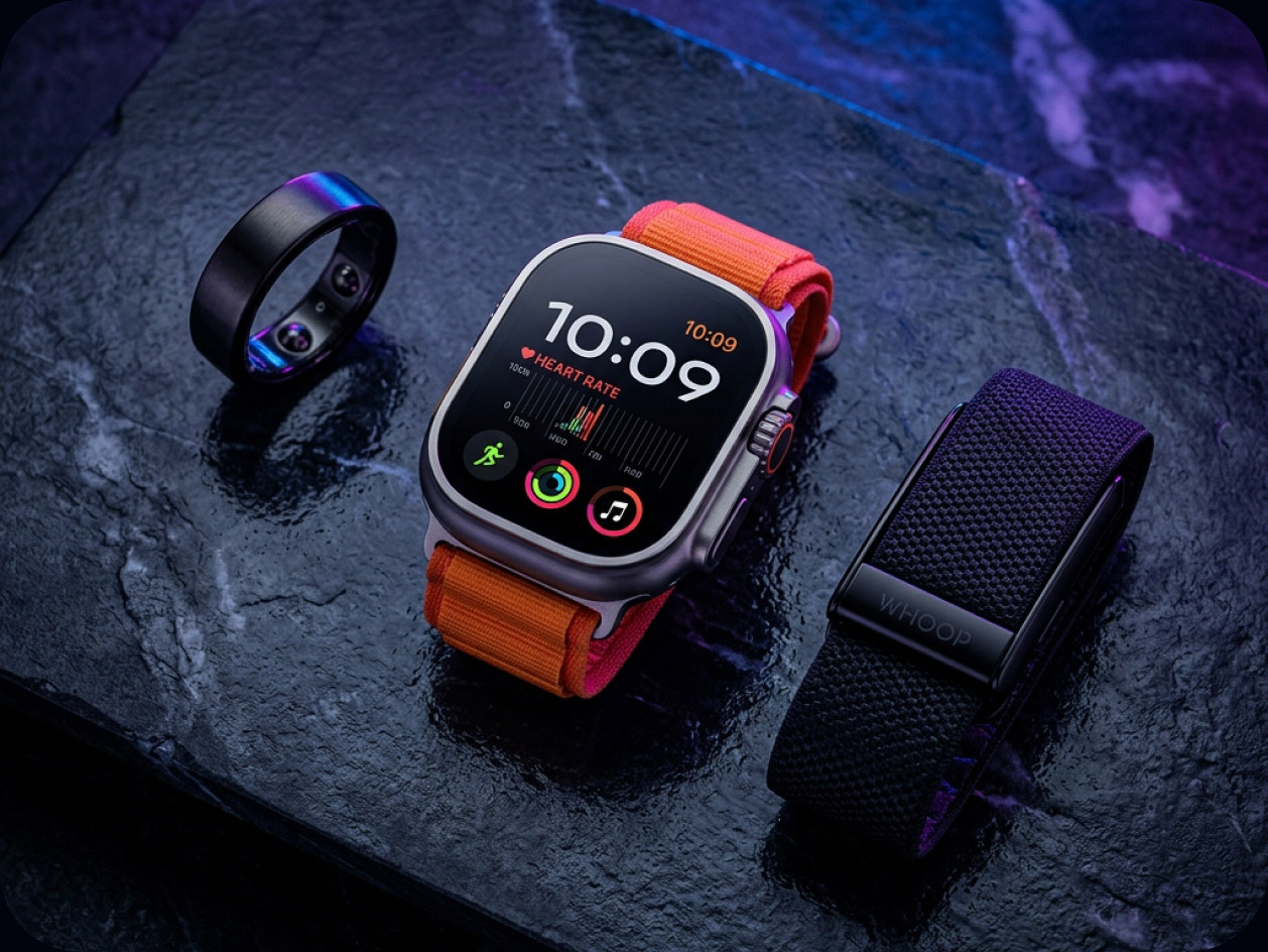 Smart ring, smartwatch and fitness band on a dark surface